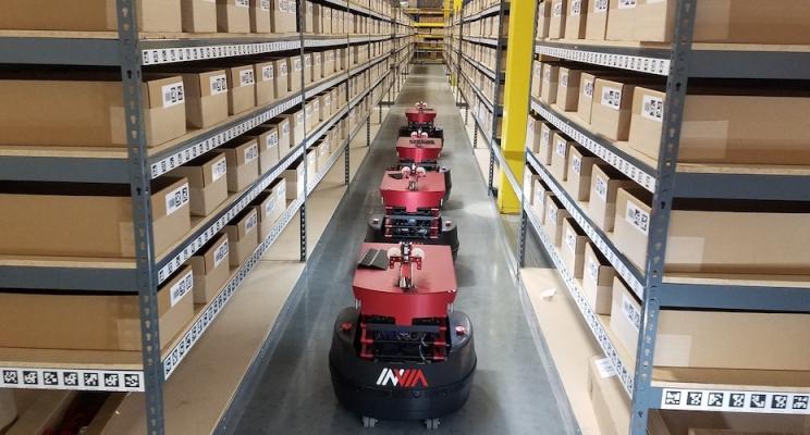 AMR Robots Retrieving Goods In Modern Warehouse