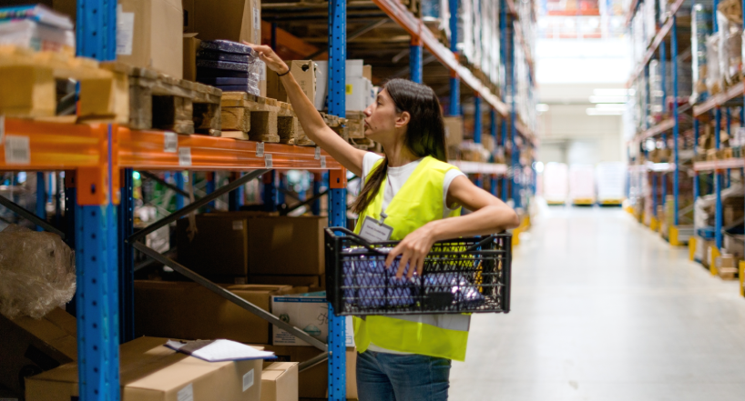 Women picking order items in warehouse from shelving