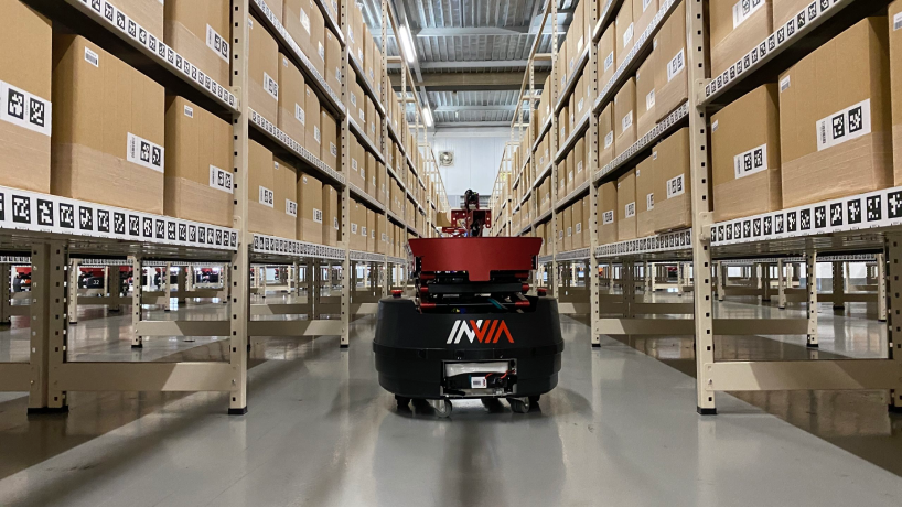 inVia picker robot navigating between shelving in warehouse